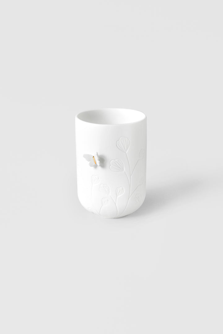 Photophore en porcelaine blanche motif floraux et papillon en relief sur le côté 4avril